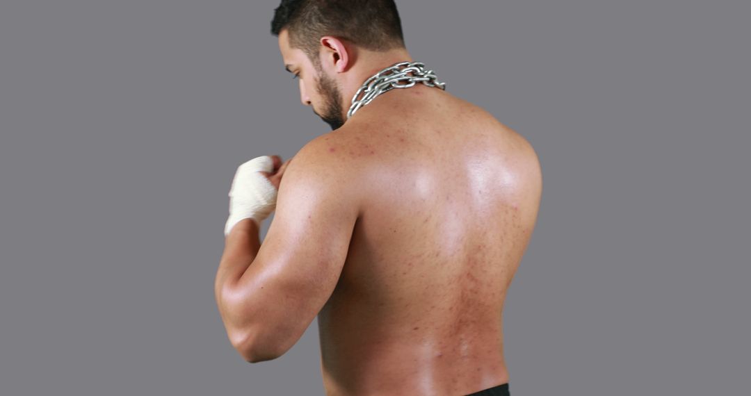 Muscular Fighter Wrapping Hands for Training