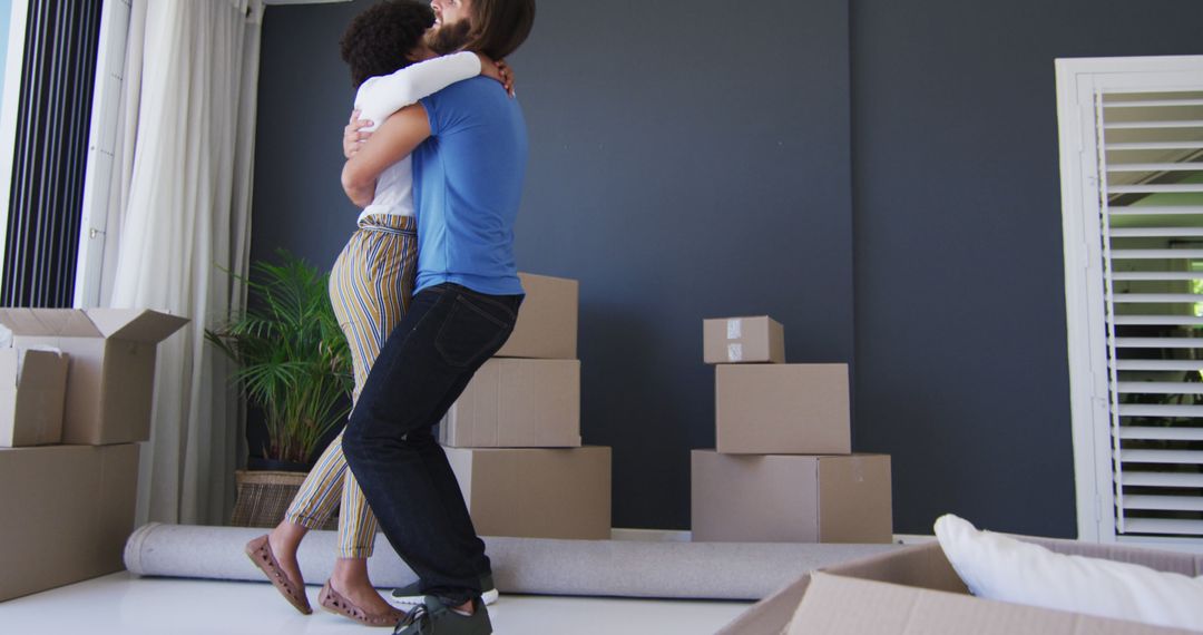 Couple Hugging While Moving into New Home with Packed Boxes - Free Images, Stock Photos and Pictures on Pikwizard.com