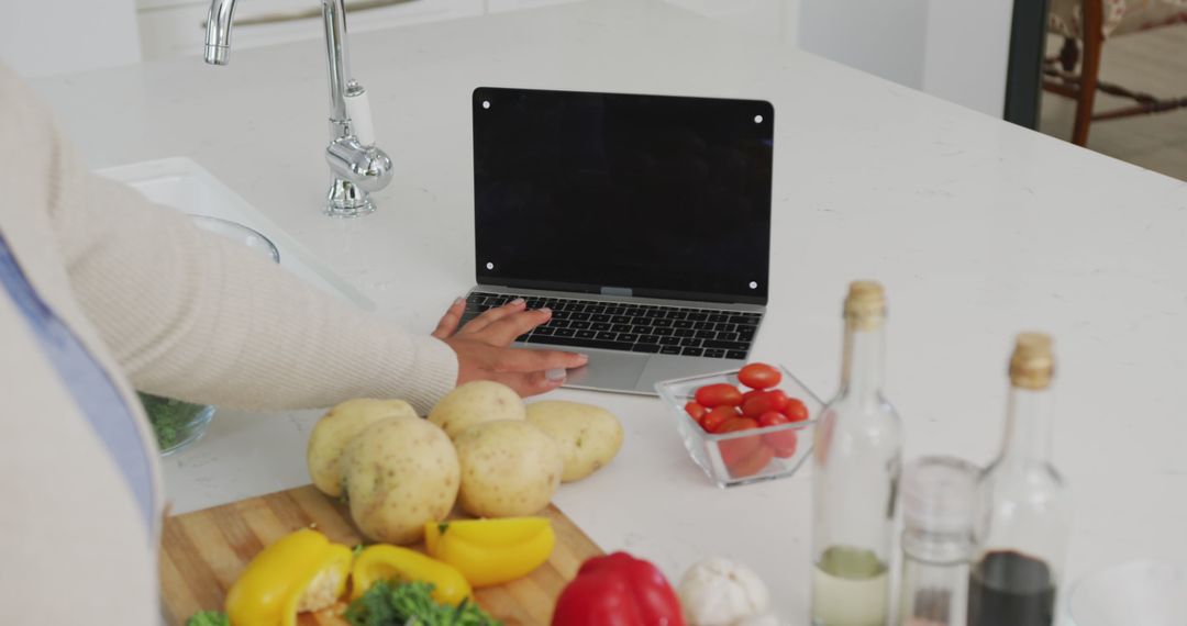 Preparing Healthy Meal Using Laptop in Modern Kitchen