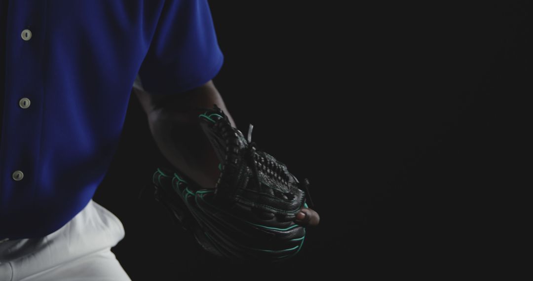 Baseball Player Wearing Blue Jersey Holding Ball Glove - Free Images, Stock Photos and Pictures on Pikwizard.com