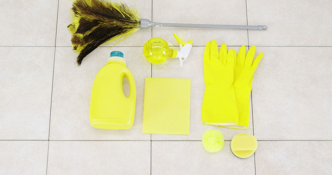 Assorted Yellow Cleaning Supplies on Tiled Floor - Free Images, Stock Photos and Pictures on Pikwizard.com