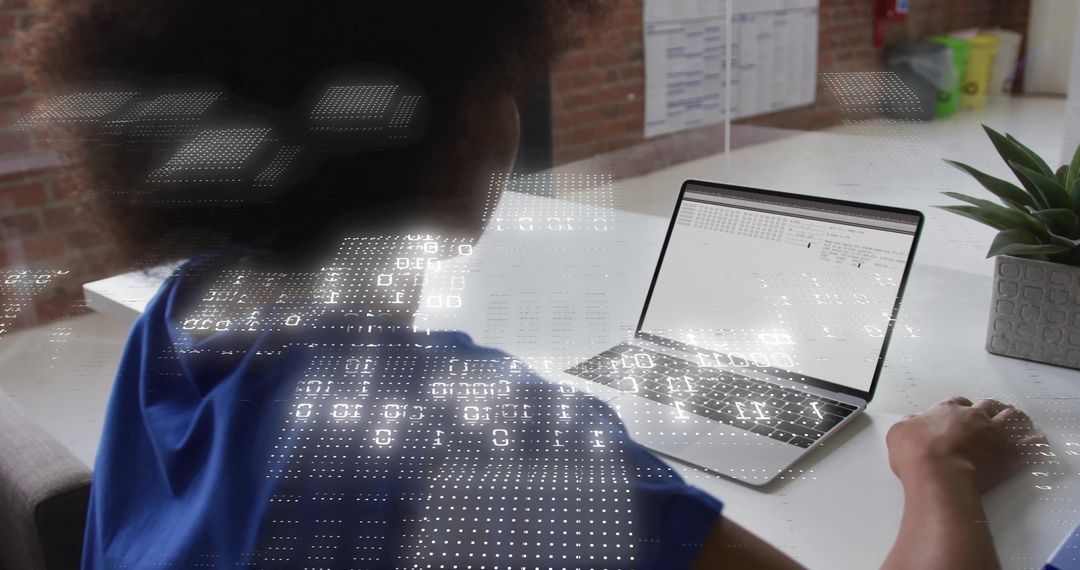 Woman Working on Laptop with Data Visualizations in Modern Office