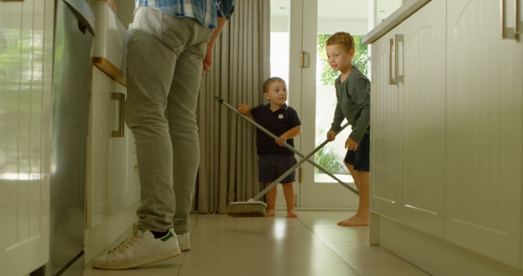 Father and Young Sons Cleaning Together in Modern Kitchen - Free Images, Stock Photos and Pictures on Pikwizard.com