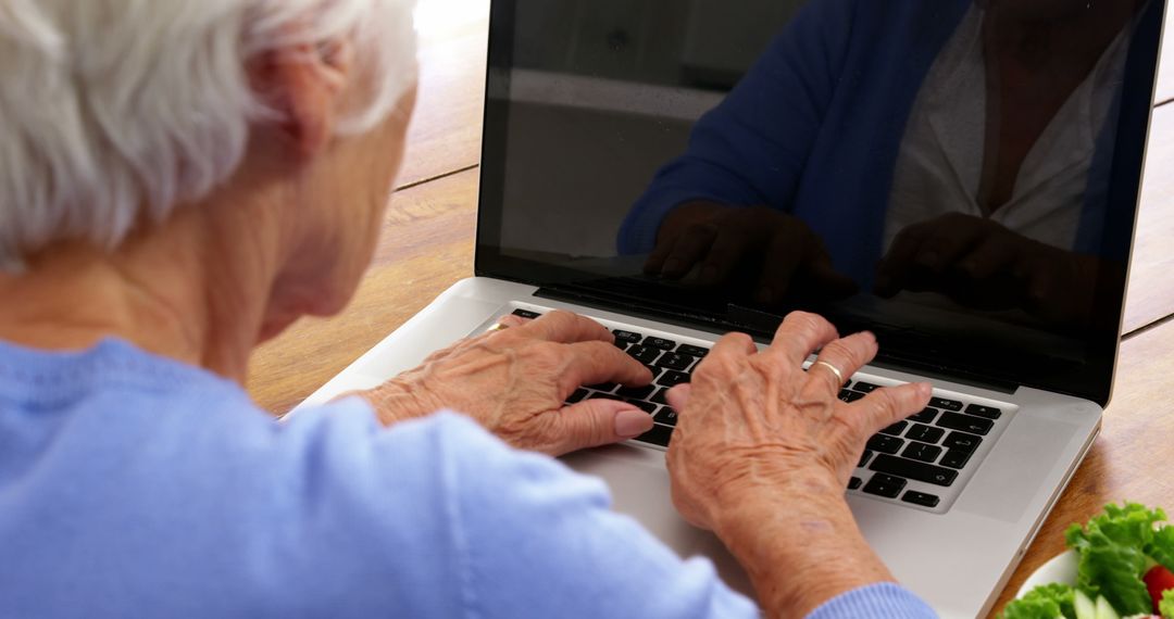 Senior Woman Typing on Laptop Computer at Home - Free Images, Stock Photos and Pictures on Pikwizard.com