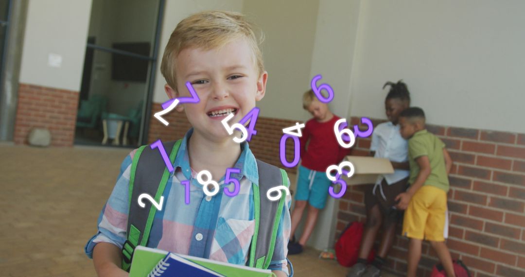 Joyful Schoolboy Holding Notebook in School Corridor