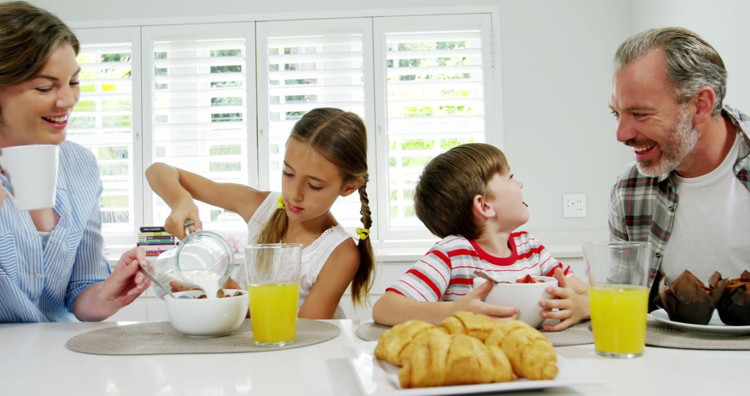 Happy Family Having Breakfast Together at Bright, Modern Kitchen Table - Free Images, Stock Photos and Pictures on Pikwizard.com