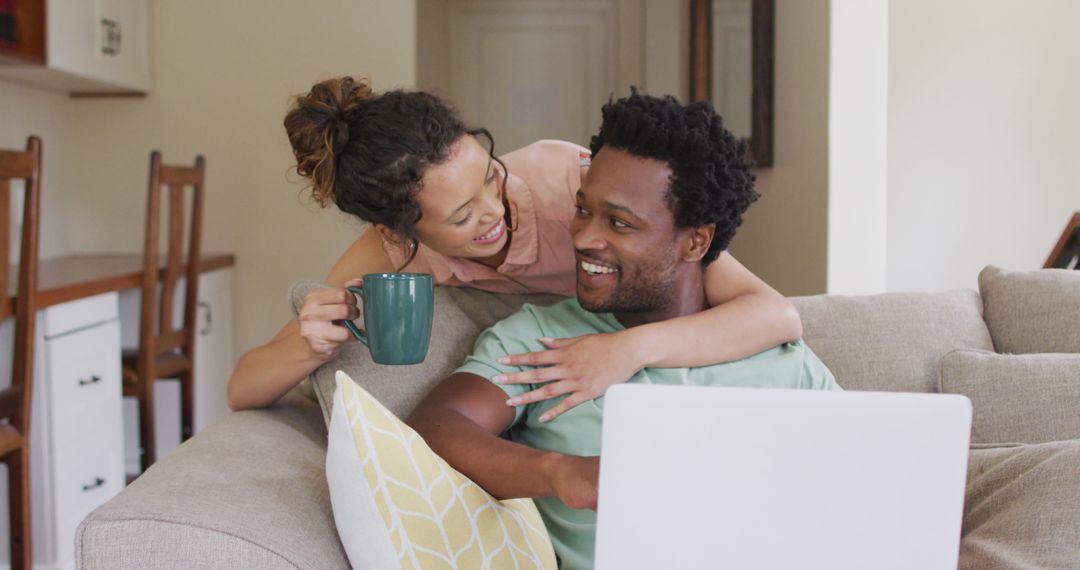 Couple Relaxing at Home with Laptop and Coffee