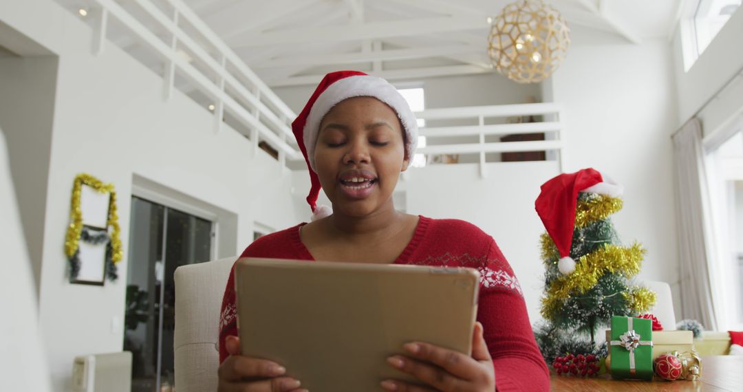 Young Woman Celebrating Christmas Online with Tablet - Free Images, Stock Photos and Pictures on Pikwizard.com