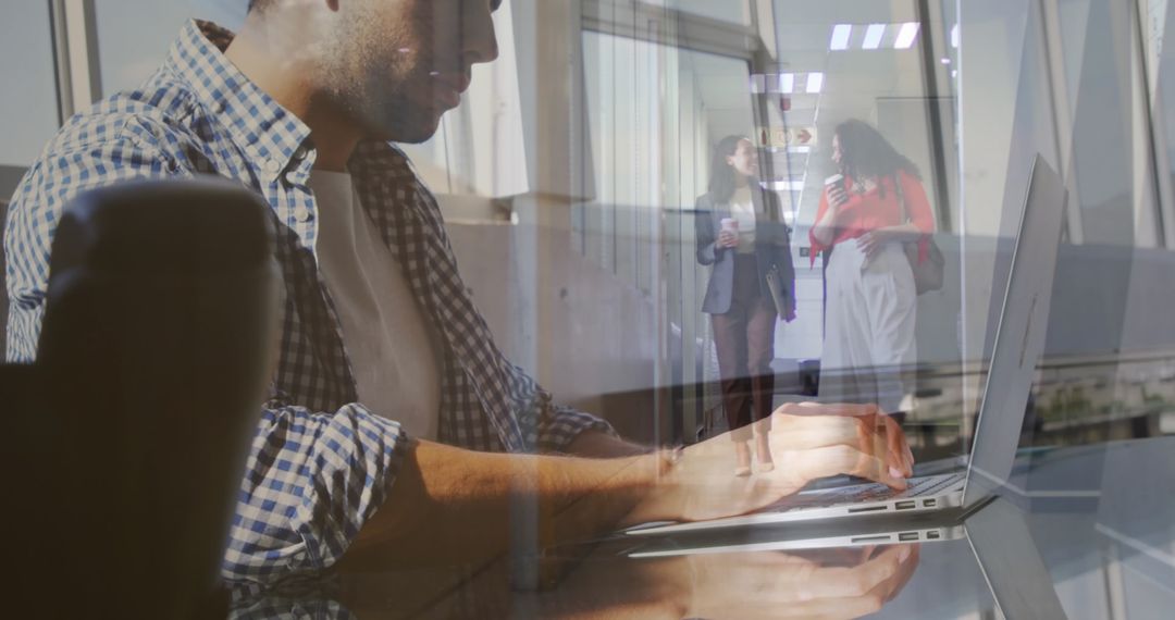 Double Exposure of Businessman Typing and Colleagues Walking
