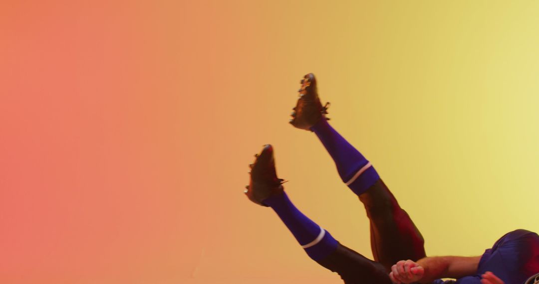 Soccer Player Falling on Colorful Gradient Background - Free Images, Stock Photos and Pictures on Pikwizard.com