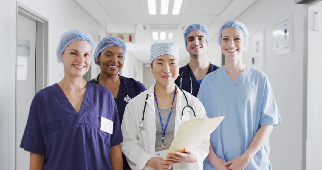 Image of diverse group of happy medical workers in surgical caps smiling in hospital corridor - Free Images, Stock Photos and Pictures on Pikwizard.com