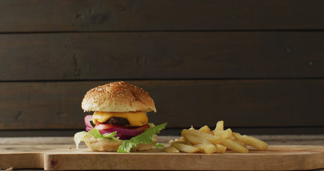 Delicious Cheeseburger with French Fries on Wooden Board - Free Images, Stock Photos and Pictures on Pikwizard.com