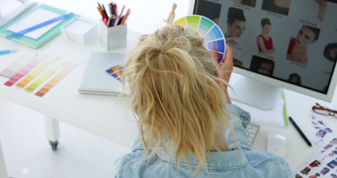 Female Graphic Designer Working on Computer with Color Swatch - Free Images, Stock Photos and Pictures on Pikwizard.com