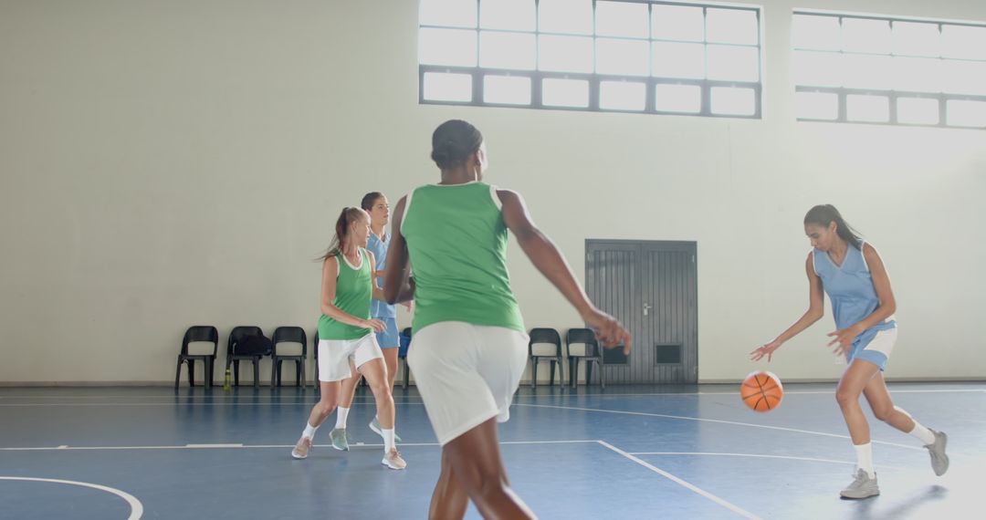 Diverse Female Athletes Playing Energetic Game of Basketball