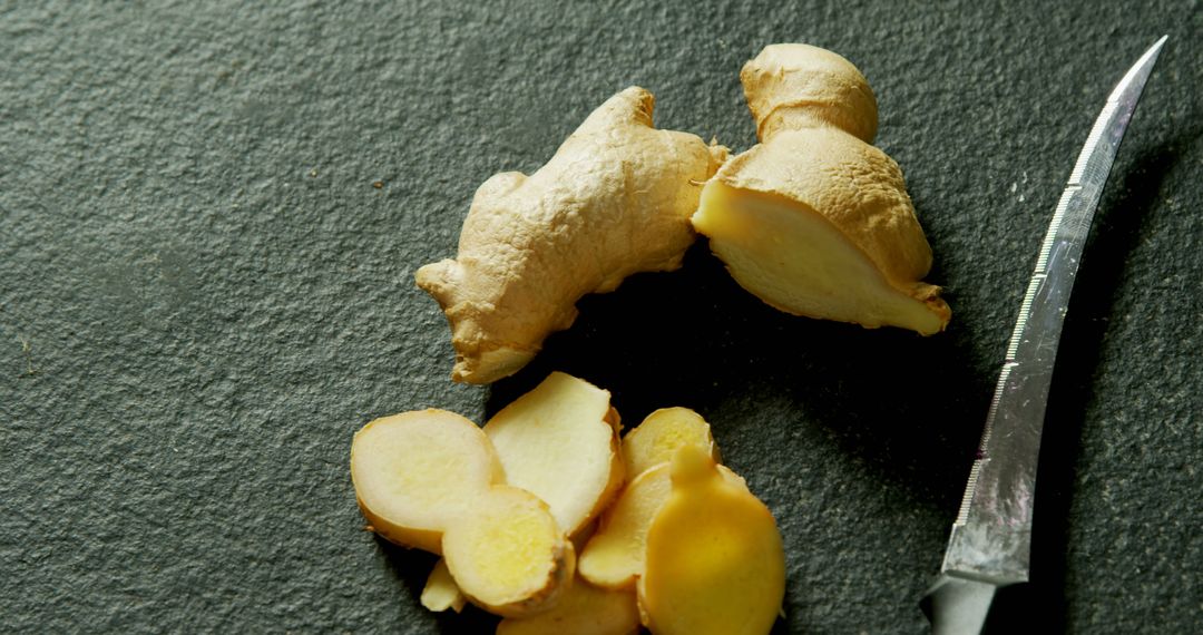 Fresh Ginger Root and Sliced Pieces on Dark Slate Surface - Free Images, Stock Photos and Pictures on Pikwizard.com