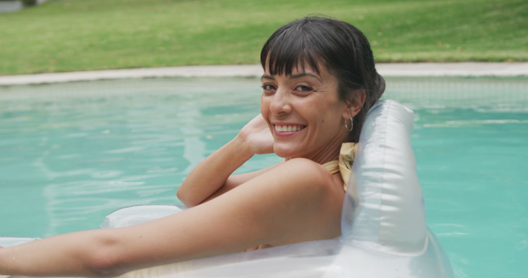 Joyful Woman Relaxing on Inflatable in Swimming Pool - Free Images, Stock Photos and Pictures on Pikwizard.com