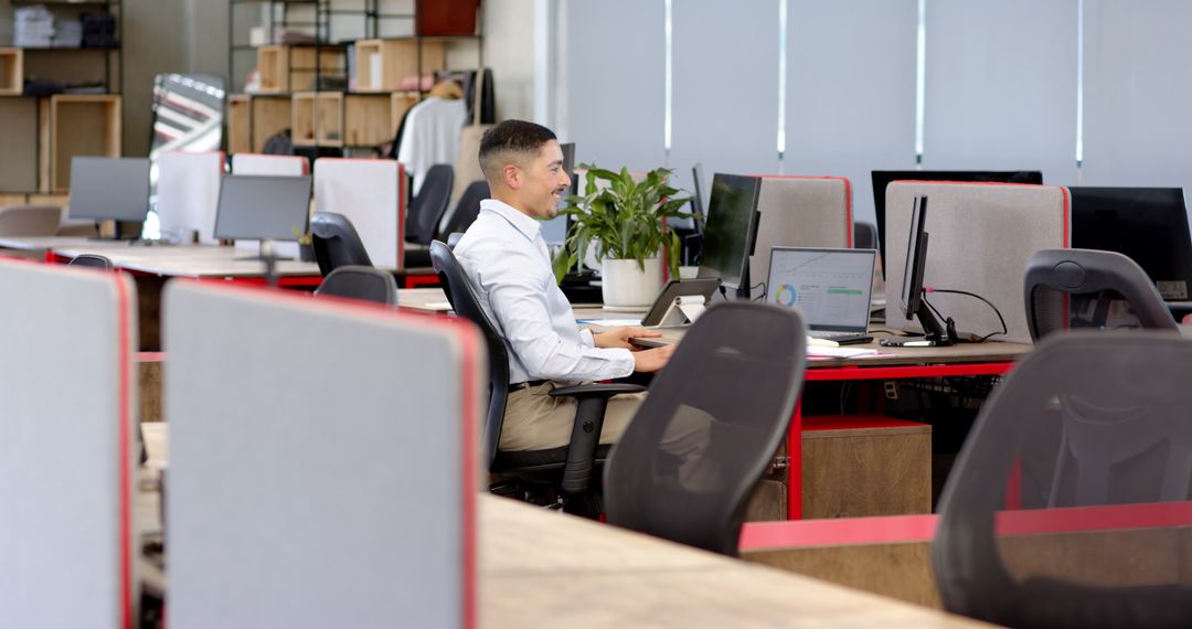 Confident Businessman Working Alone in a Modern Open Office