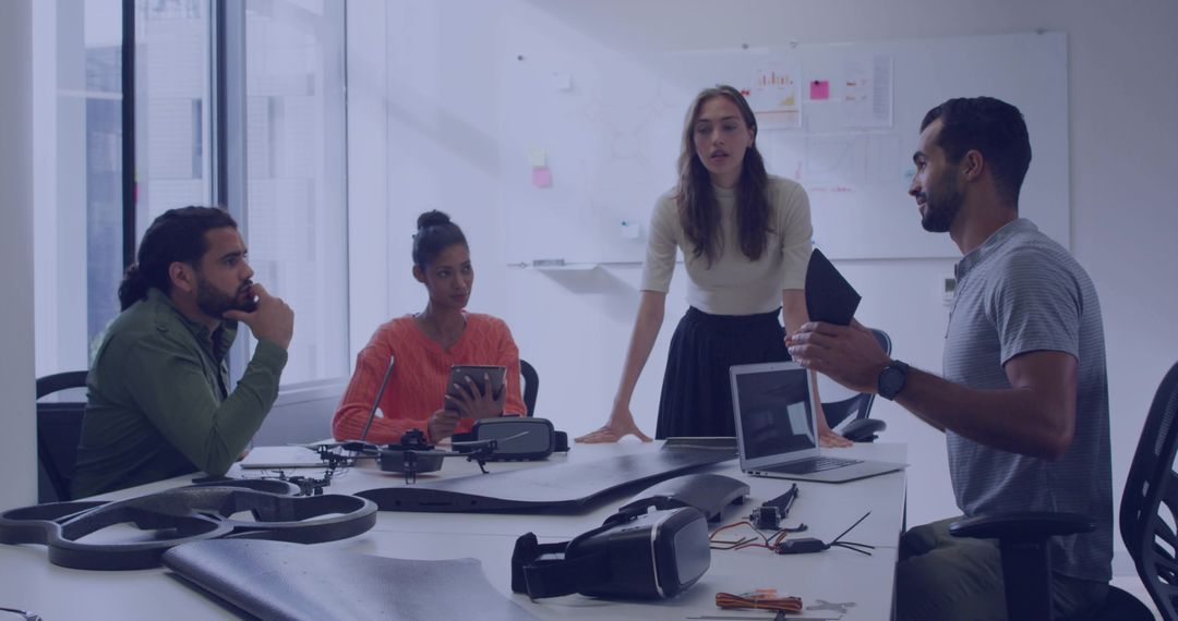 Engineers collaborating on drone and VR prototype design during hands-on product development meeting