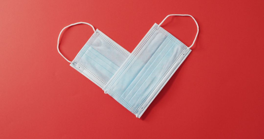 Heart-Shaped Face Masks on Red Background for Valentine's Day