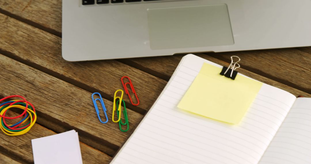 Organized Workspace with Laptop and Colorful Stationery