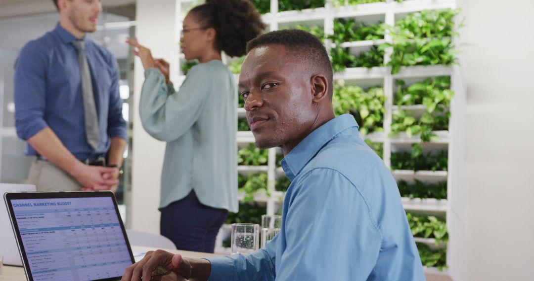 Confident Businessman Working in Modern Green Office Environment