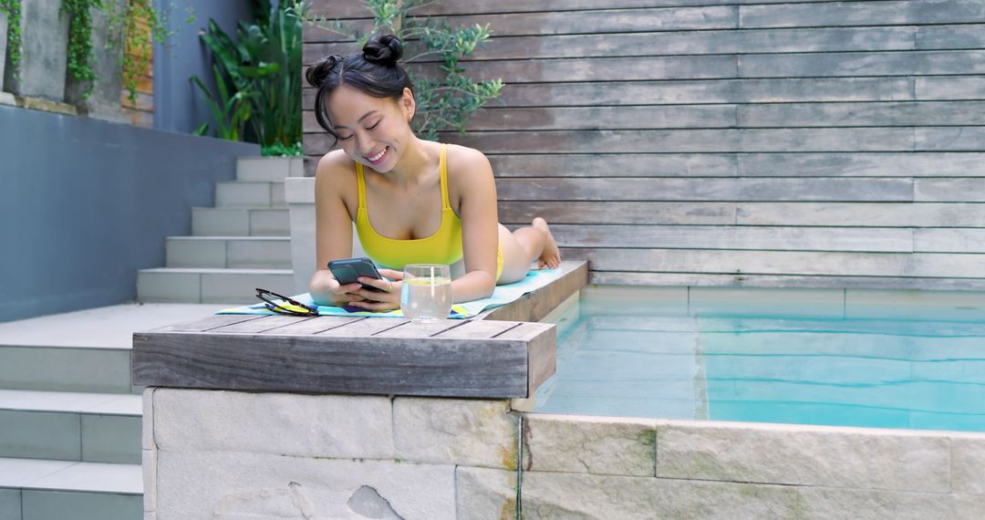 Woman Enjoying Relaxing Moment Poolside with Smartphone