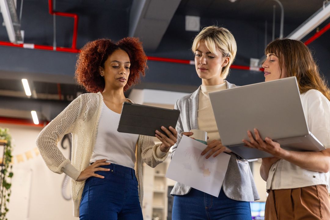 Diverse Team Collaborating in Modern Office with Technology Resources