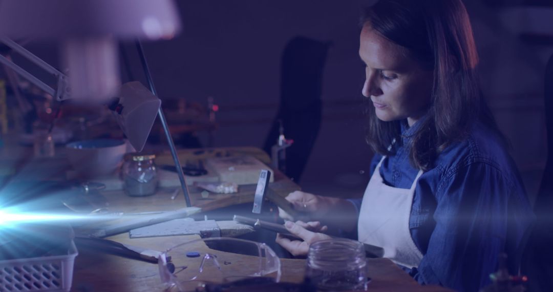 Craftswoman Diligently Using Tools at Workshop Desk