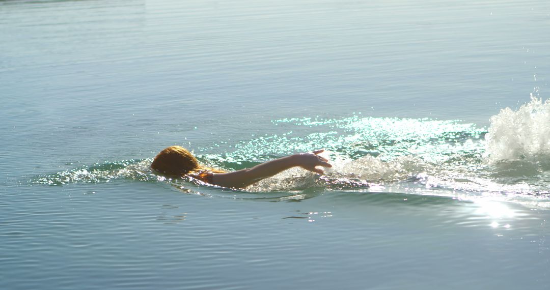 Person Swimming in Calm Lake Waters During Sunset - Free Images, Stock Photos and Pictures on Pikwizard.com