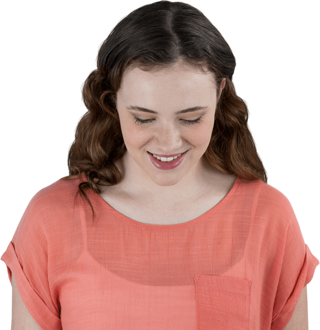 Smiling Woman in Coral Top Looking Down Relaxed Expression Transparent Background