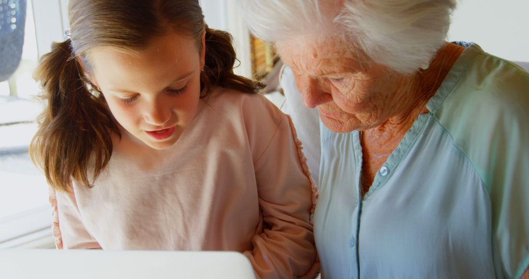 Grandmother and Young Girl Bonding Over Tablet - Free Images, Stock Photos and Pictures on Pikwizard.com