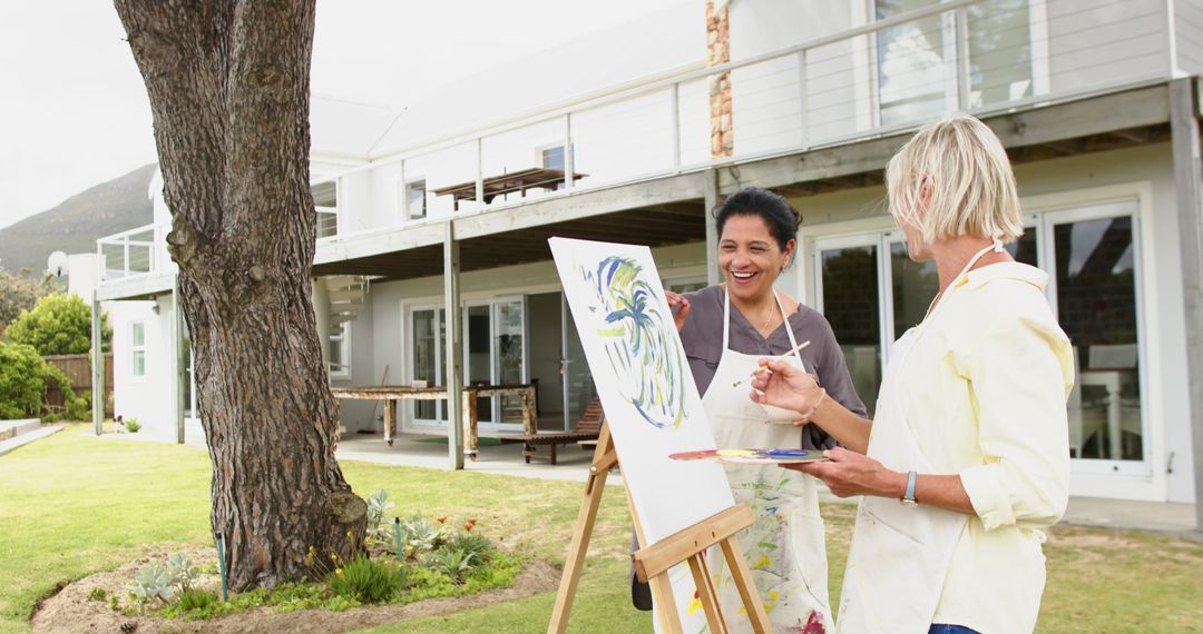 Women Painting Outdoors By Canvas In Garden - Free Images, Stock Photos and Pictures on Pikwizard.com