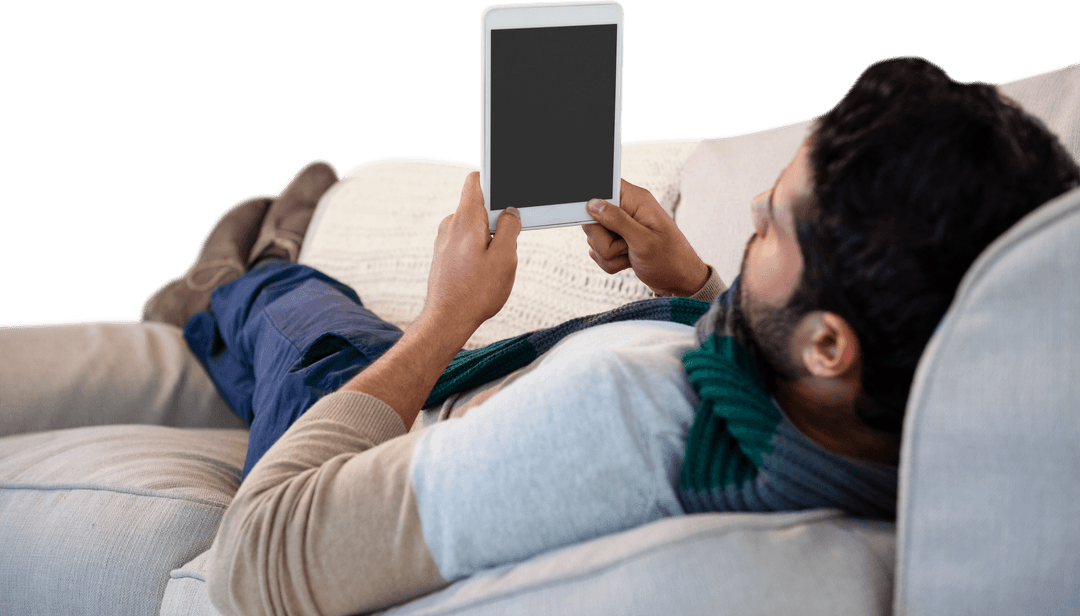 Relaxed Young Man Lying on Sofa Using Digital Tablet Transparent Background