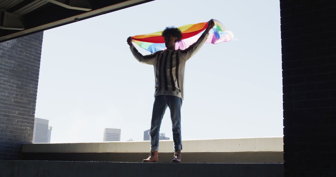 Person Holding Rainbow Flag in Urban Location - Free Images, Stock Photos and Pictures on Pikwizard.com