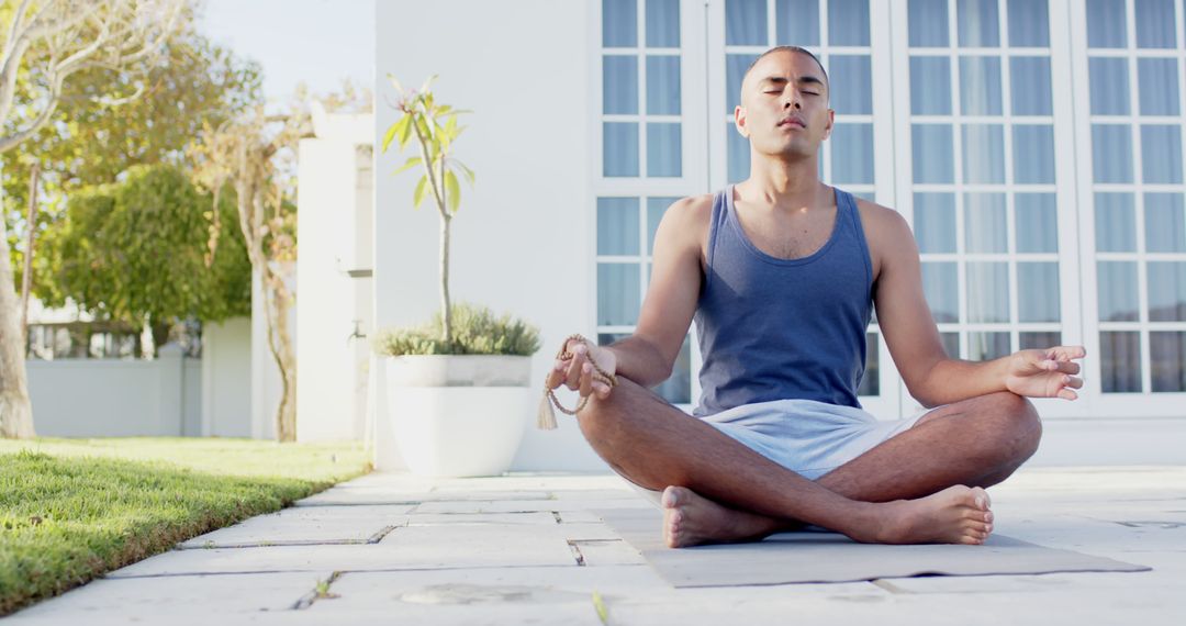 Man Meditating Outdoors in Garden on Sunny Day - Free Images, Stock Photos and Pictures on Pikwizard.com