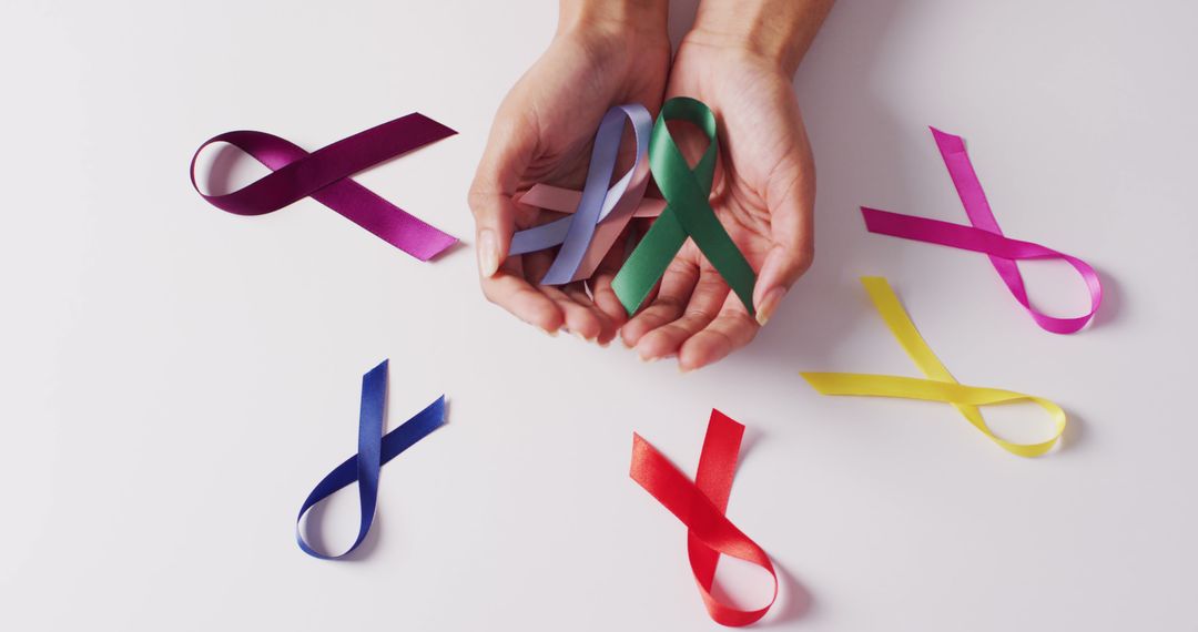 Image of hands of caucasian woman holding colorful ribbons on white background - Free Images, Stock Photos and Pictures on Pikwizard.com