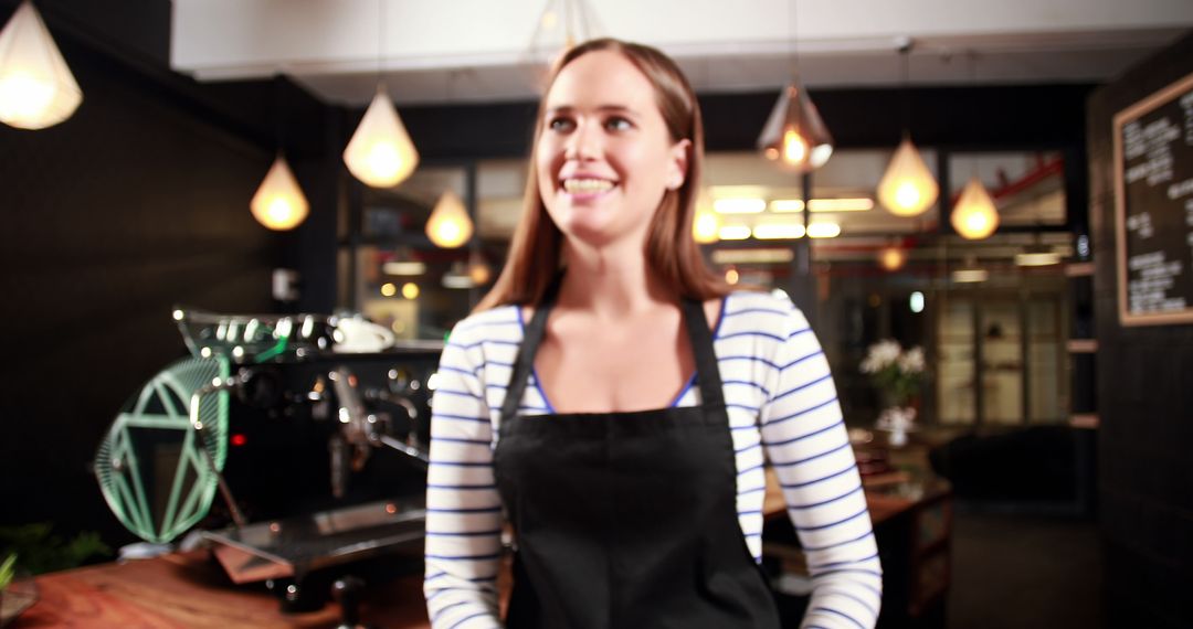 Smiling barista in cosy coffee shop with modern decor - Free Images, Stock Photos and Pictures on Pikwizard.com