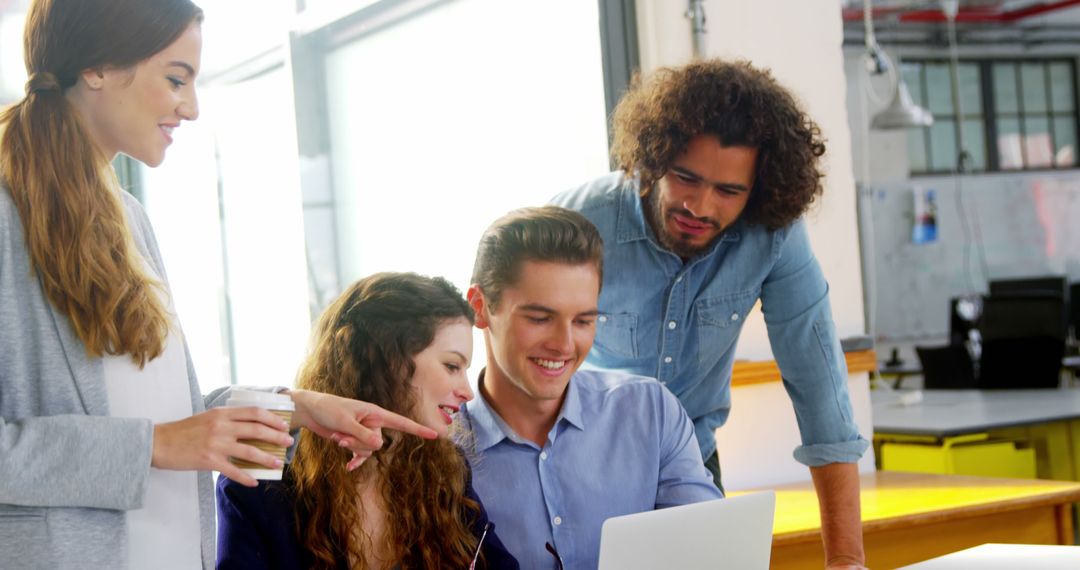 Team Collaboration Over Laptop in Modern Office Space