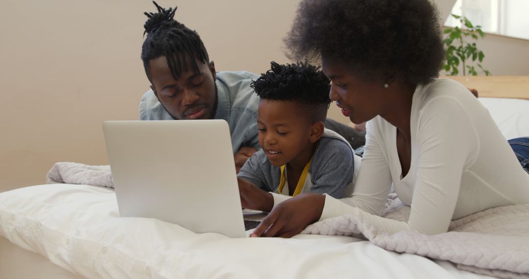 African American Family Using Laptop Together on Bed - Free Images, Stock Photos and Pictures on Pikwizard.com