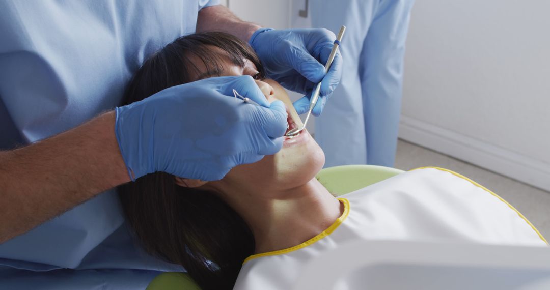 Dentist Examining Patient’s Teeth with Dental Instruments - Free Images, Stock Photos and Pictures on Pikwizard.com