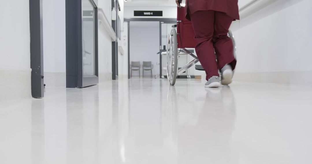 Medical Professional Walking Down Clean Hospital Corridor - Free Images, Stock Photos and Pictures on Pikwizard.com