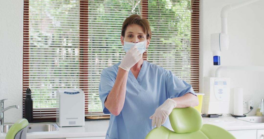 Female Dentist Wearing Mask and Gloves in Clinic Adjusting Face Mask - Free Images, Stock Photos and Pictures on Pikwizard.com