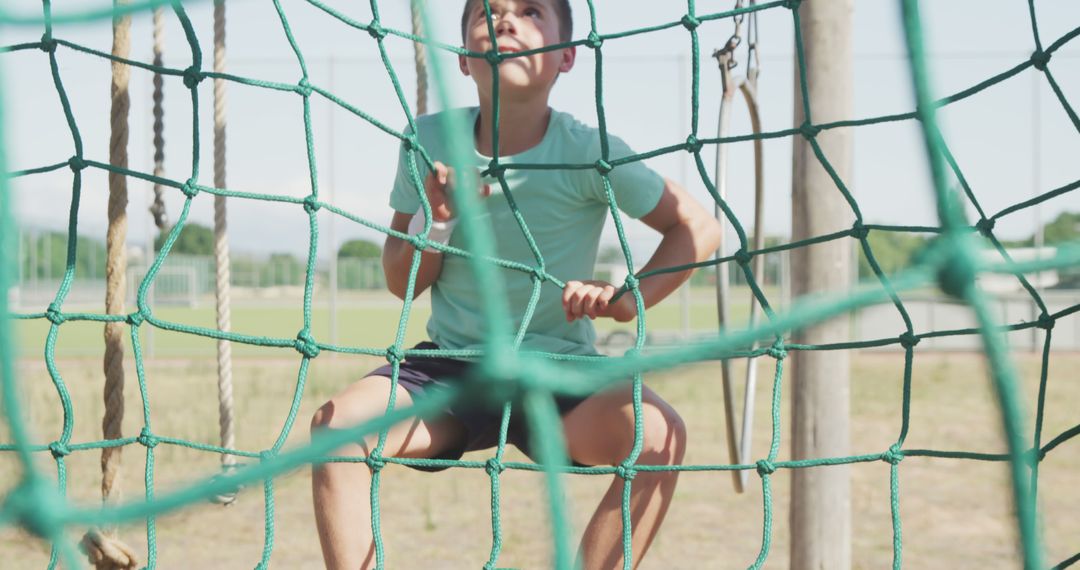 Caucasian Boy Climbing Rope Net in Outdoor Playground - Free Images, Stock Photos and Pictures on Pikwizard.com