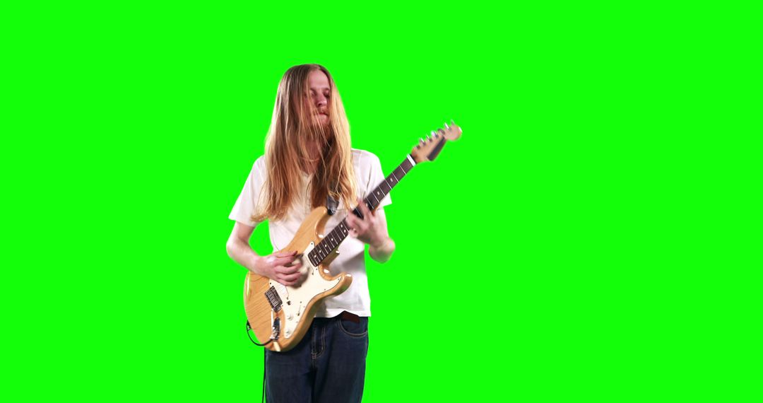 Young Guitarist with Long Hair Playing Electric Guitar Against Green Screen - Free Images, Stock Photos and Pictures on Pikwizard.com