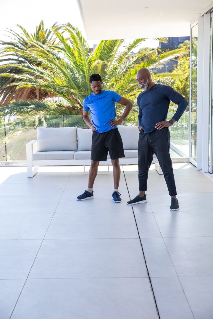 Father and Son Warm-up on Terrace with Palm Tree Backdrop