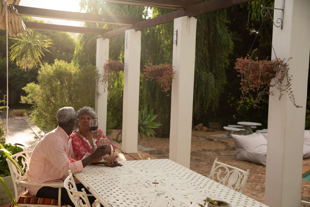 Senior African American Couple Enjoying Wine in Garden - Free Images, Stock Photos and Pictures on Pikwizard.com