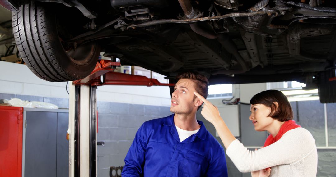 Mechanic Explaining Car Issue to Concerned Female Customer - Free Images, Stock Photos and Pictures on Pikwizard.com