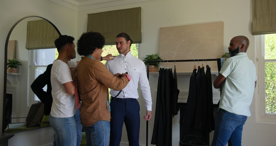 Groom Getting Ready with Friends Adjusting Outfit in Stylish Room