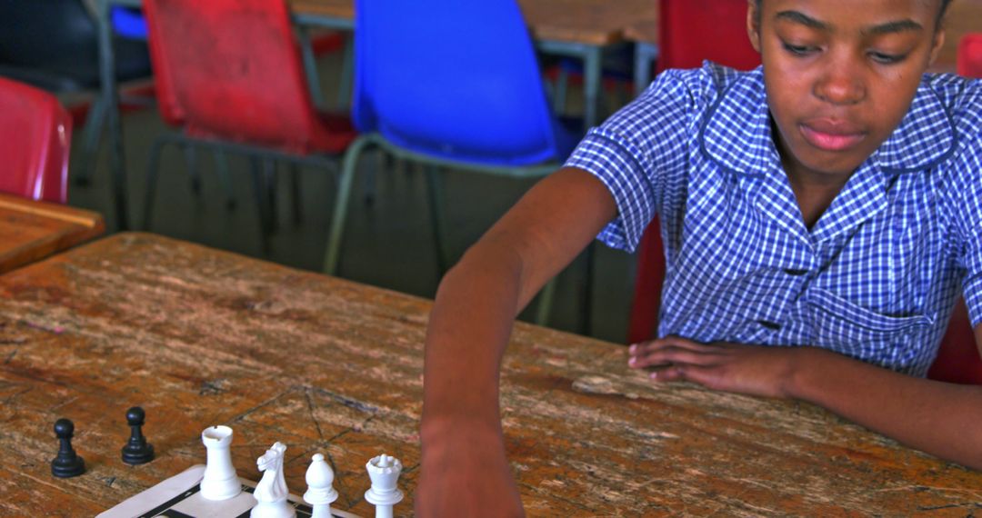 Young student playing chess in classroom - Free Images, Stock Photos and Pictures on Pikwizard.com