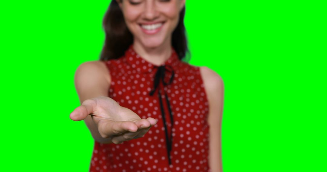 Smiling Woman Reaching Out Hand Against Green Screen Background - Free Images, Stock Photos and Pictures on Pikwizard.com